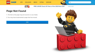 smiling LEGO figure behind a LEGO block with a computer