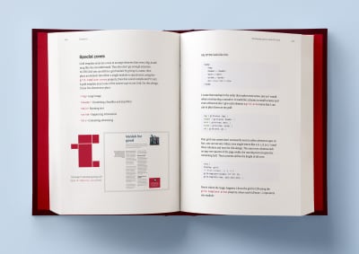 A hardcover book laying open on a light blue background, with two pages open that are showing some artwork examples of Bond conference and Medium Memberships