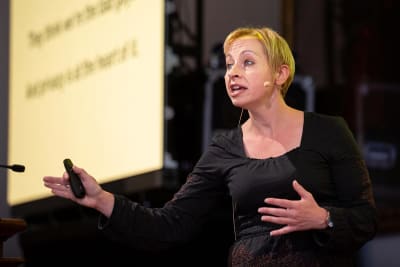 A woman presenting on stage